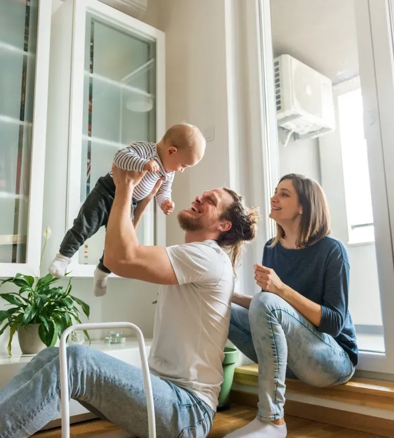 Happy family playing outdoors, parents with child in nature